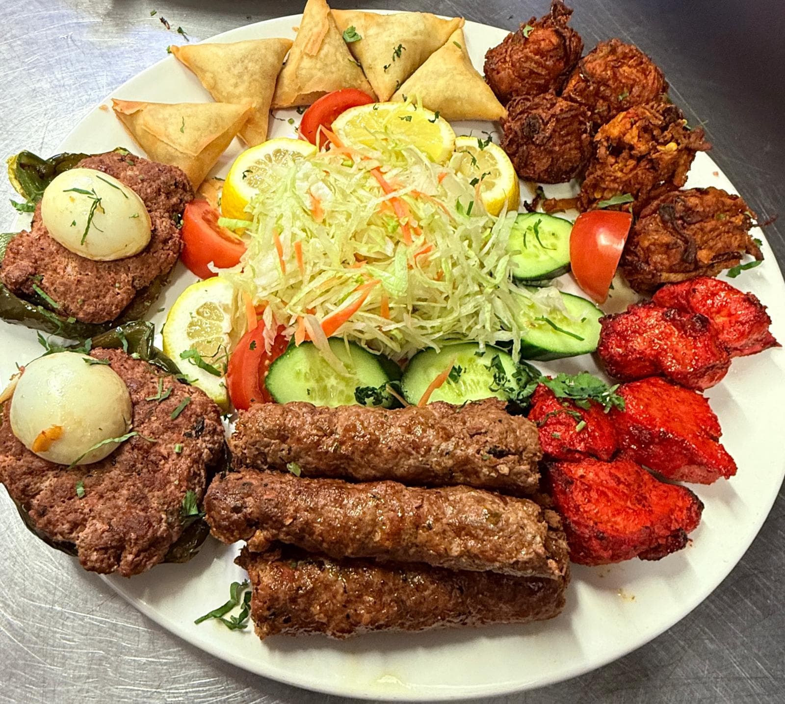 Sizzling lamb chops plated with salad garnish