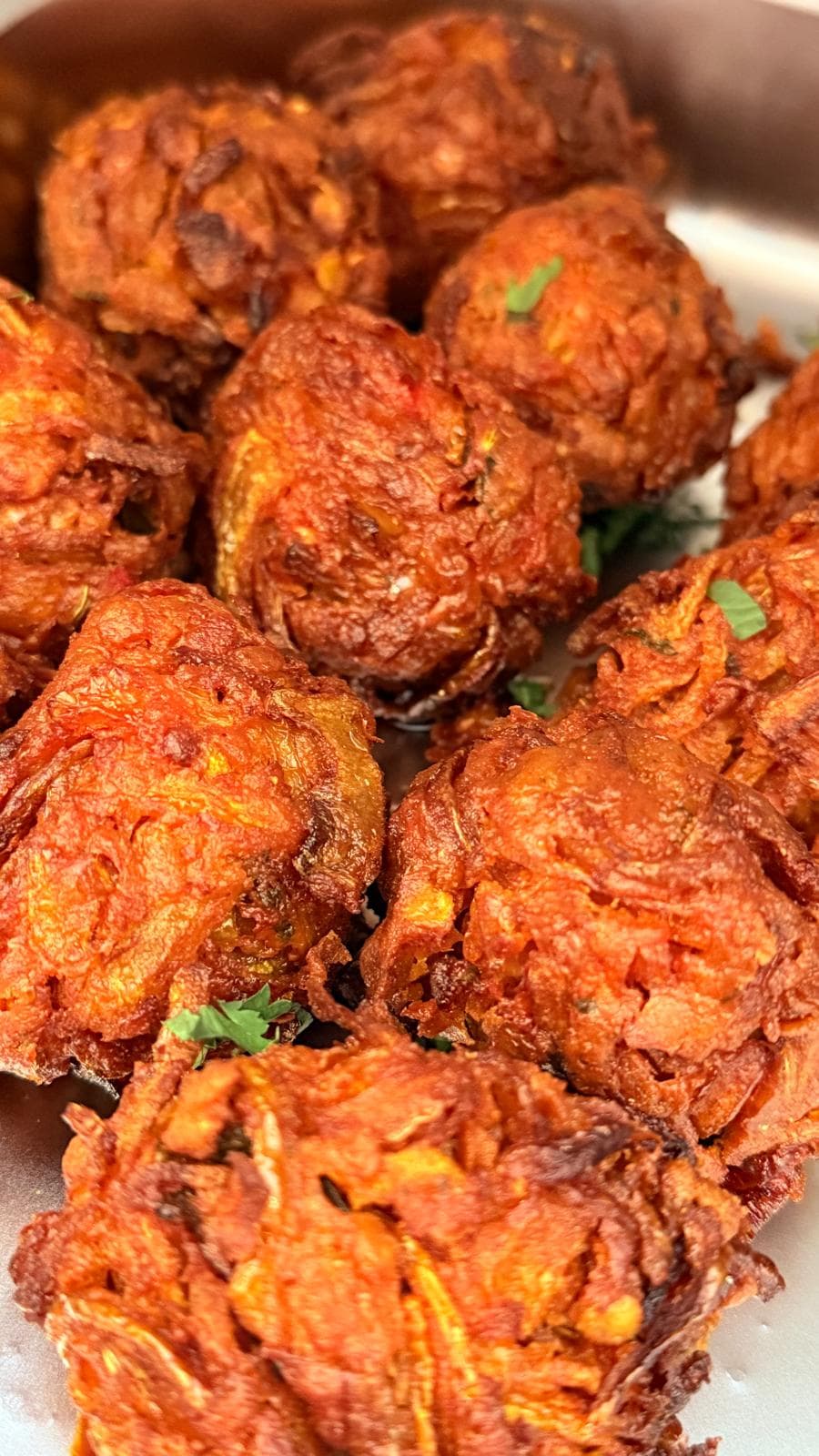 Freshly fried onion bhajis, golden and crisp