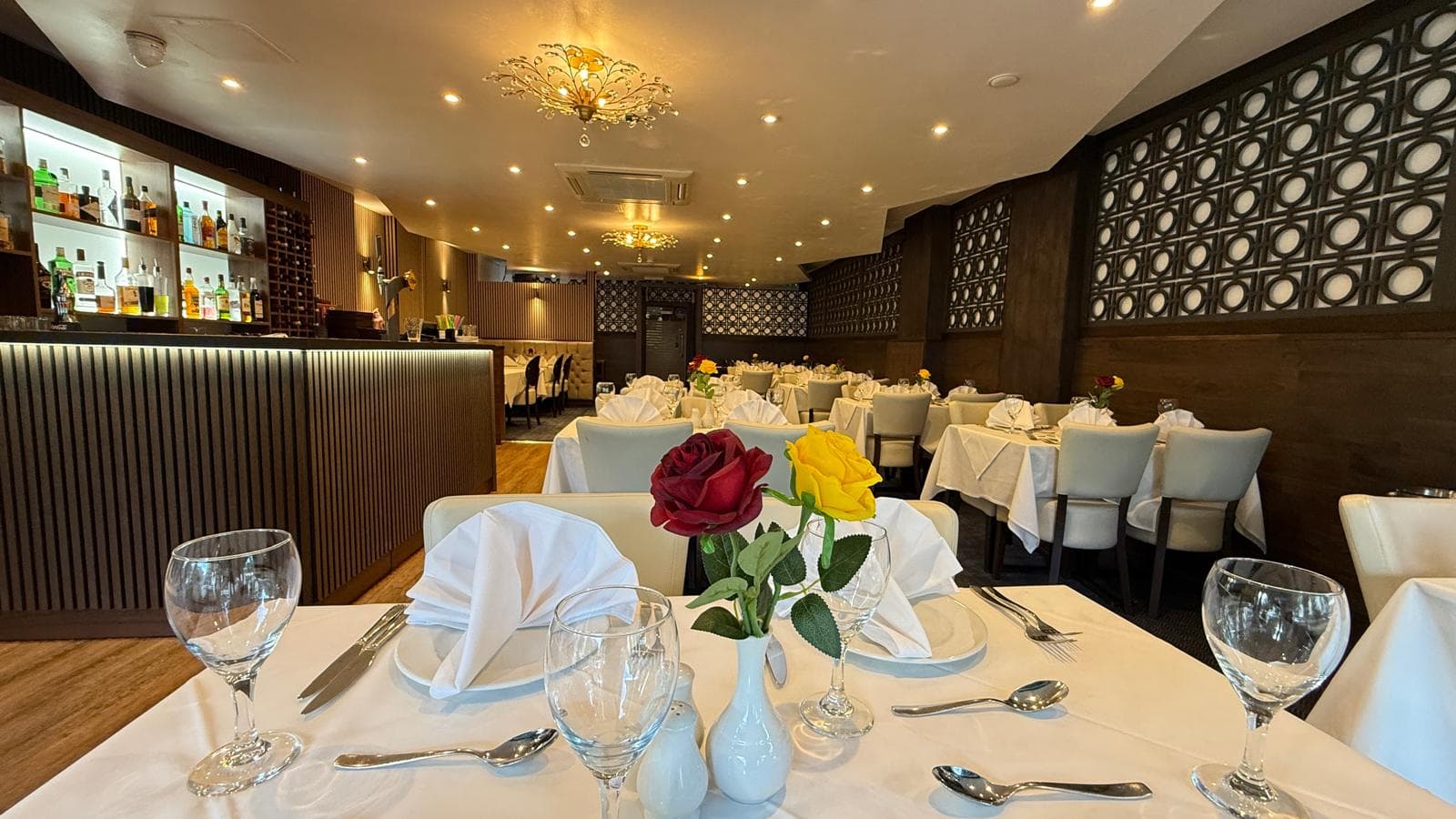 Crisp napkin folds and silver cutlery — table ready