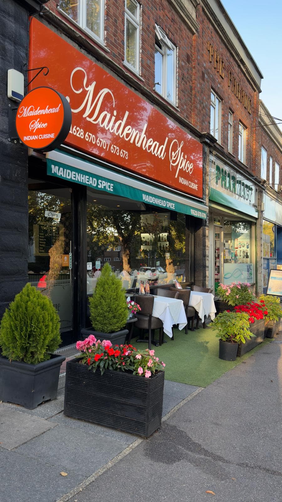 Maidenhead Spice exterior — red signage and pavement flowers