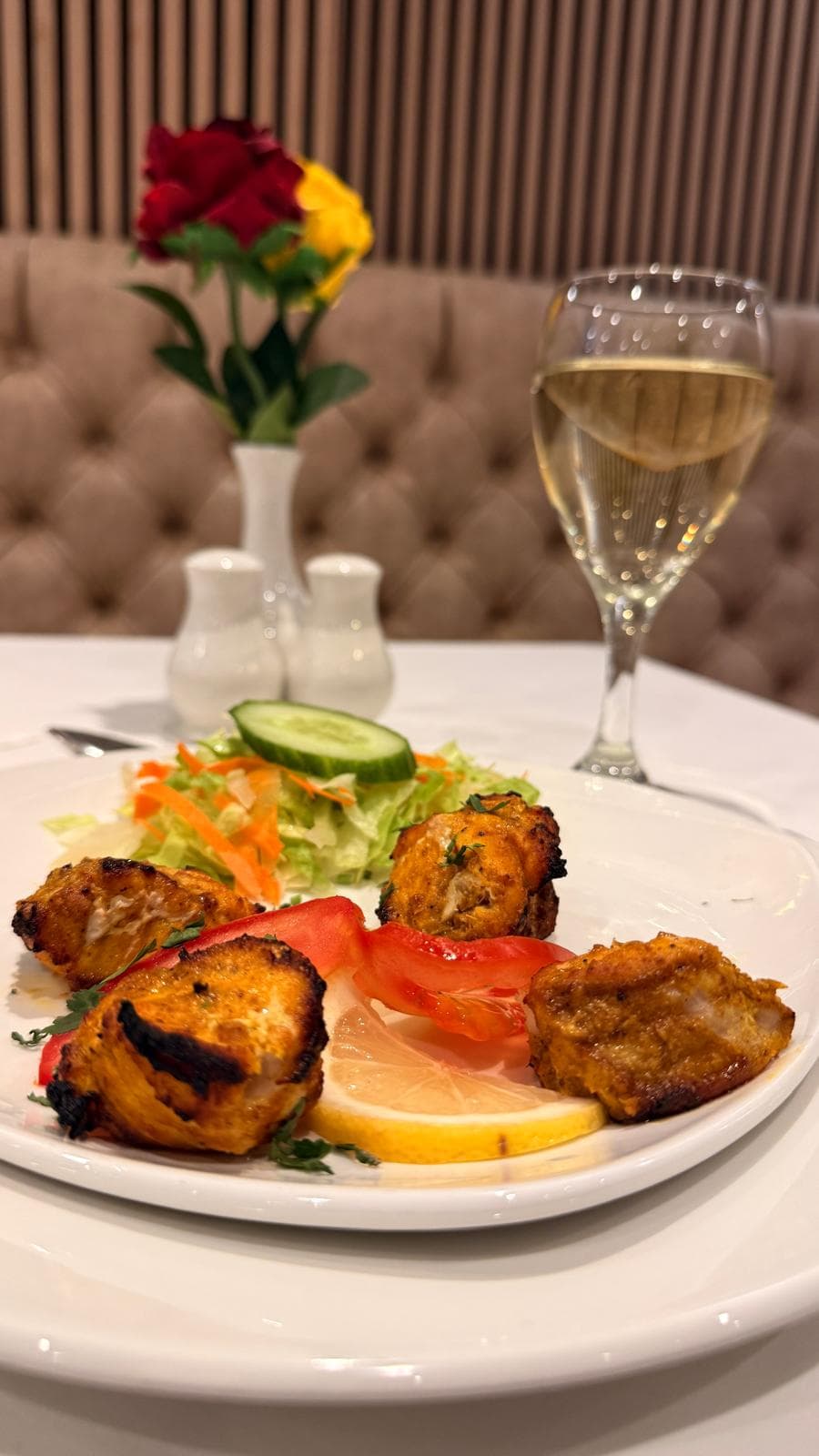 Tandoori platter with salad and a glass of wine