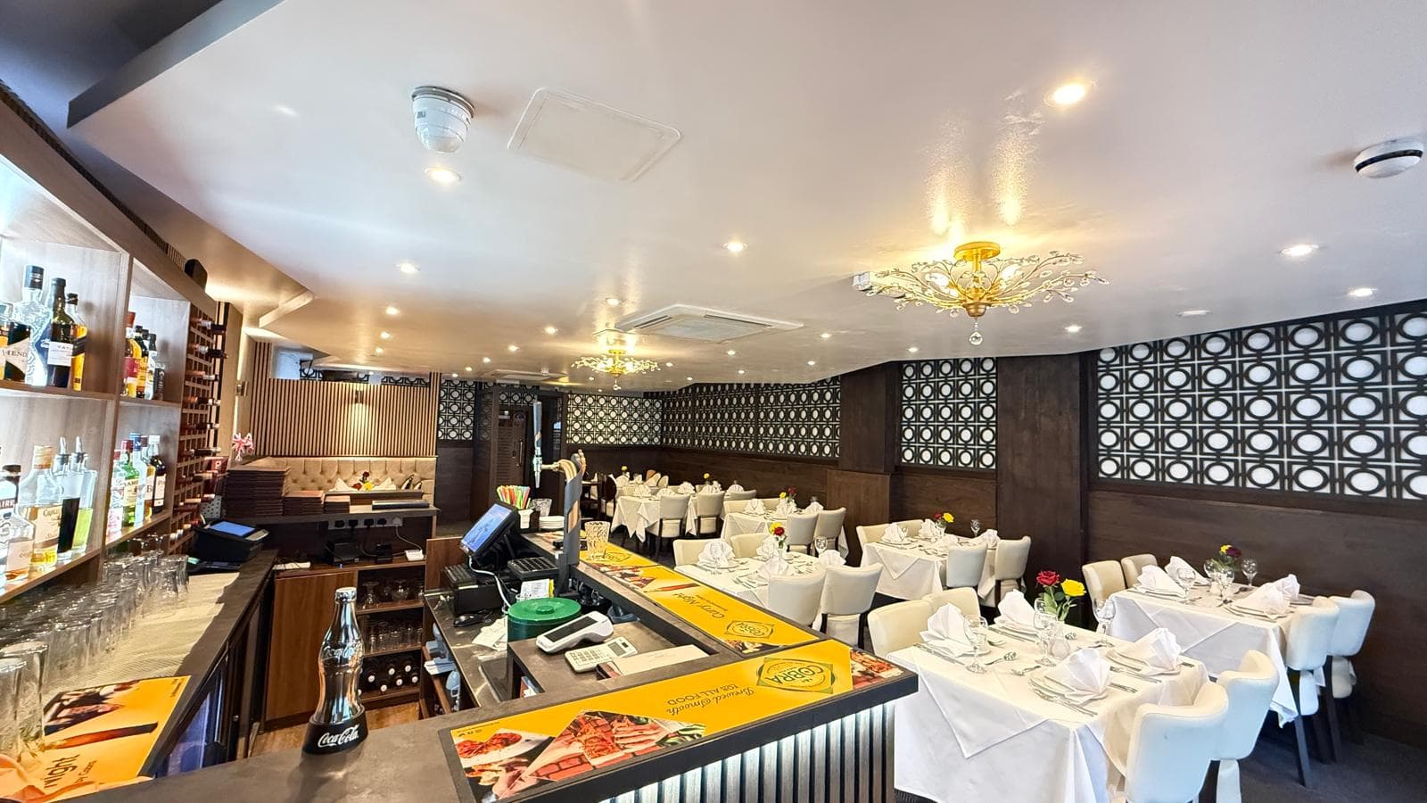 Wide view of the dining room with ornate ceiling lights