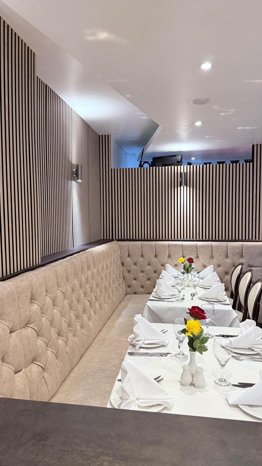Private dining booth with striped wall panelling at Maidenhead Spice